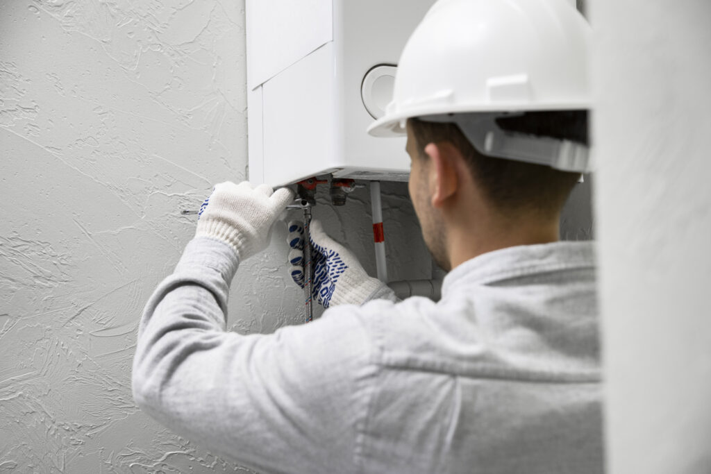 worker-repairing-water-heater-1024×683